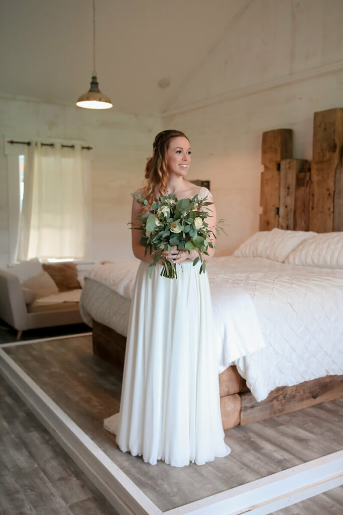 bride posing with bouquet honeymoon suite