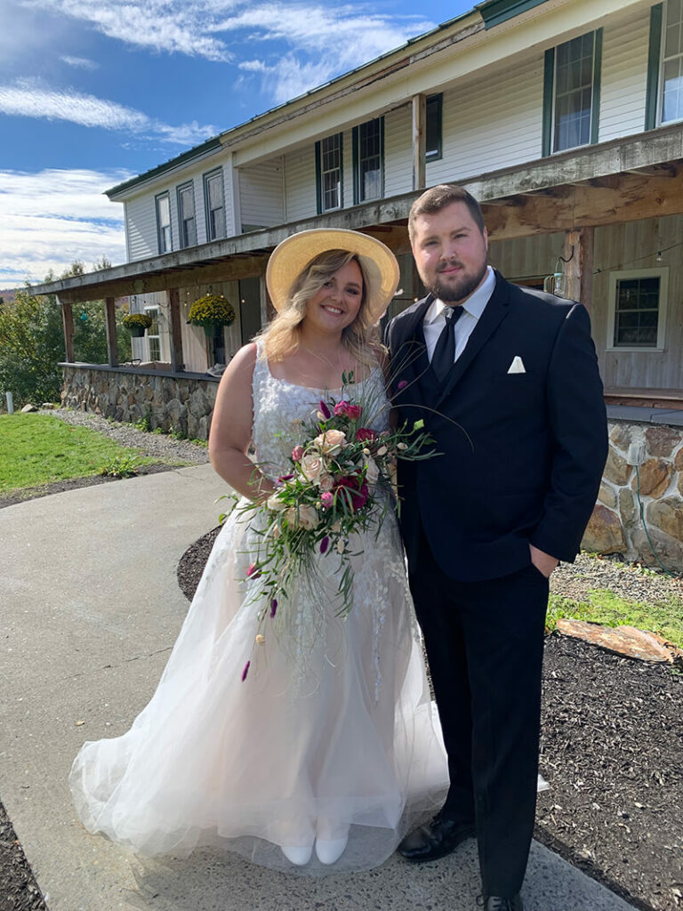 couple outside of farmhouse