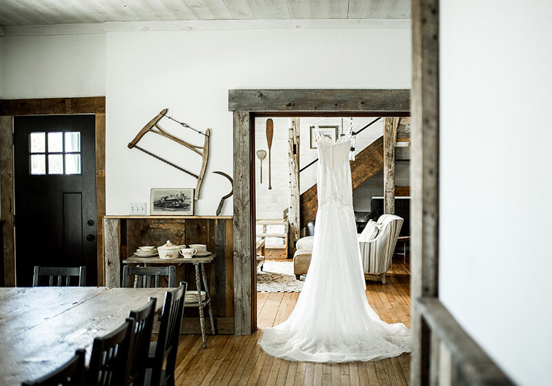 wedding dress hanging in farmhouse